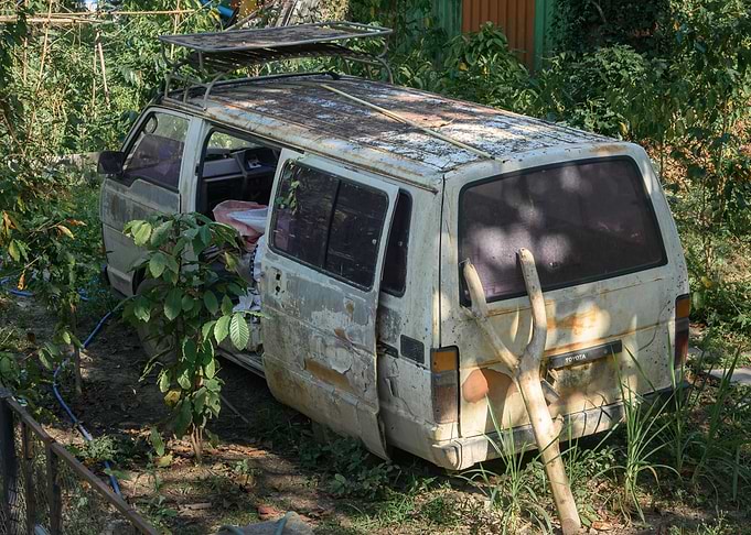 Abandoned Van in Overgrown Garden