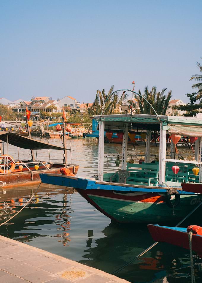 Boats docked in a canal with buildings in background