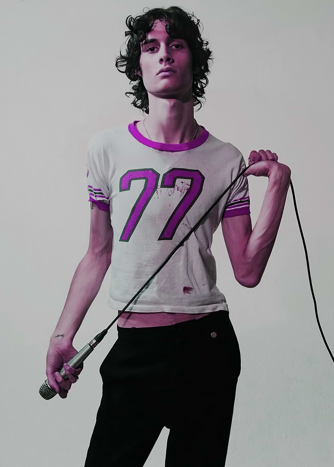 Man with Microphone and '77' Shirt
