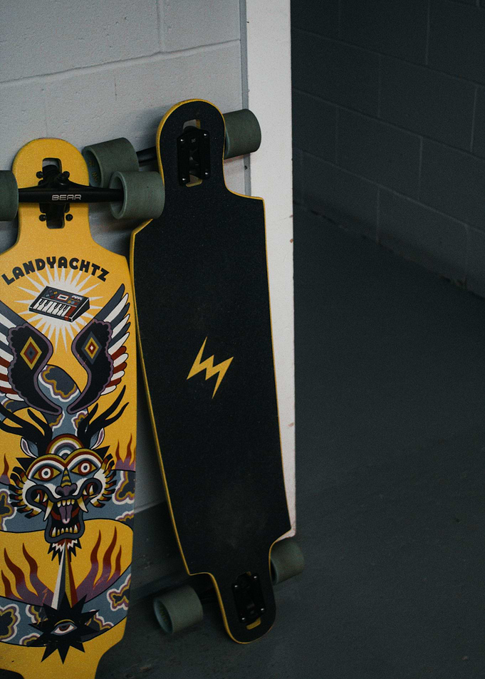 Two Longboards Leaning Against a Wall