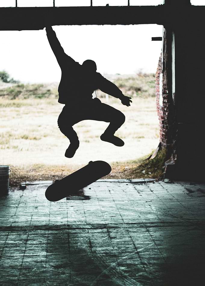 Skateboarder mid-air jump silhouette