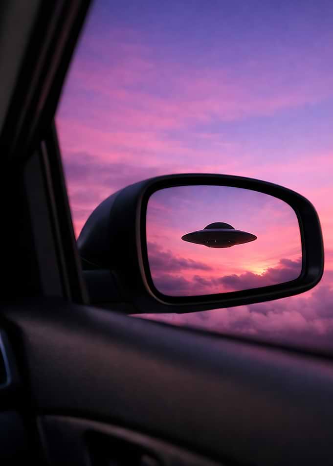 UFO in car mirror sunset