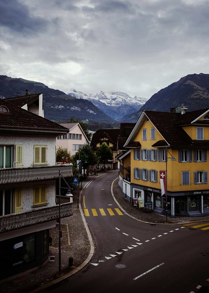 Swiss Village Street with Snow-Capped Mountains