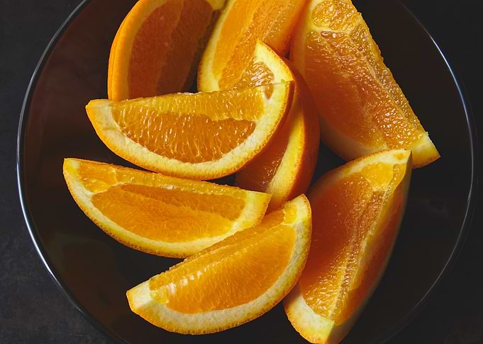 Orange Slices on a Dark Plate