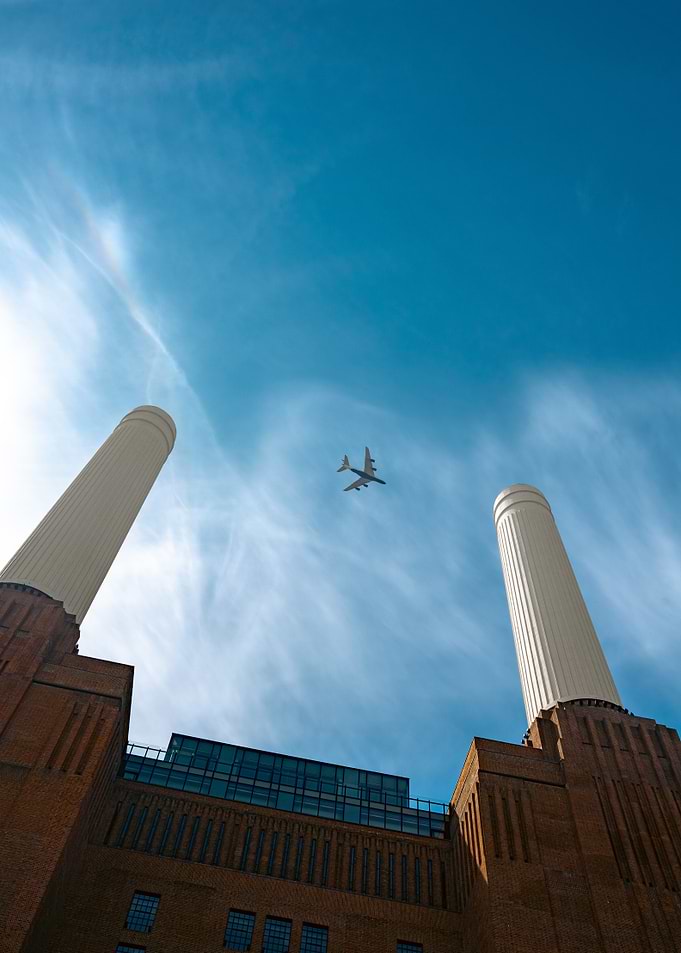 Airplane flying over Battersea Power Station