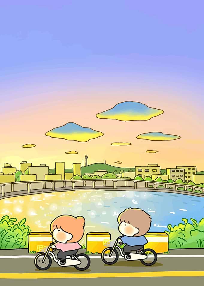 Couple Cycling by the River at Sunset