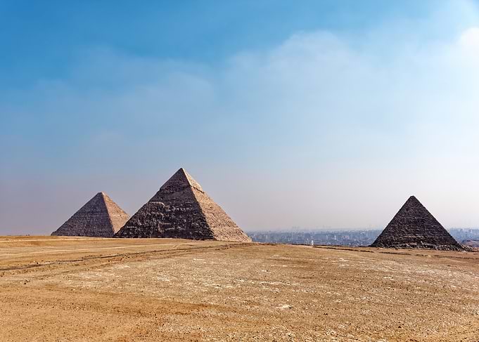 Pyramids of Giza under a blue sky