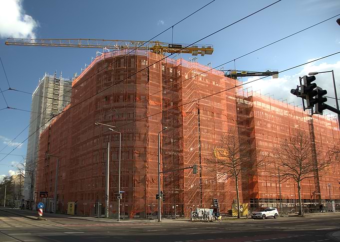Building Under Construction with Orange Scaffolding