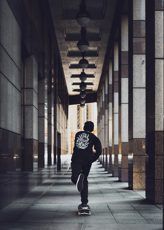 Skateboarder in Urban Corridor