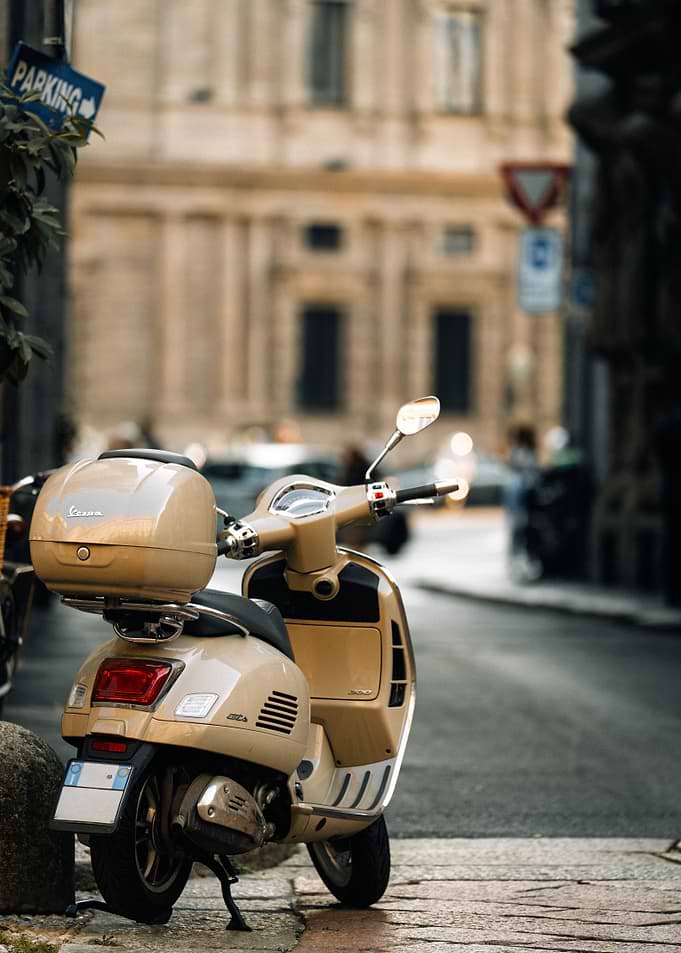 Beige Vespa Scooter on Cobblestone Street