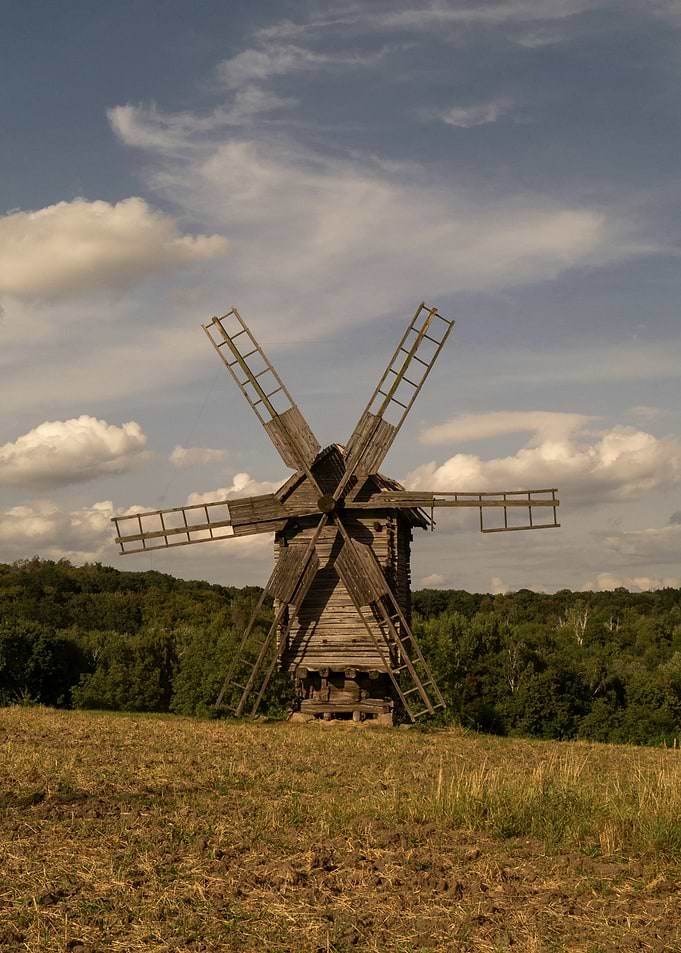 Rustic Wooden Windmill in a Field