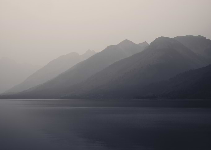 Misty Mountains Over Calm Lake