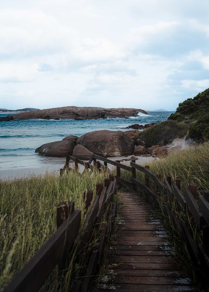 Wooden Boardwalk to an australian Rocky Beach