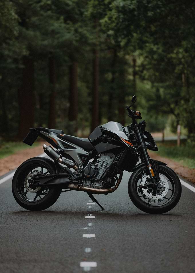 Black KTM Motorcycle on Forest Road