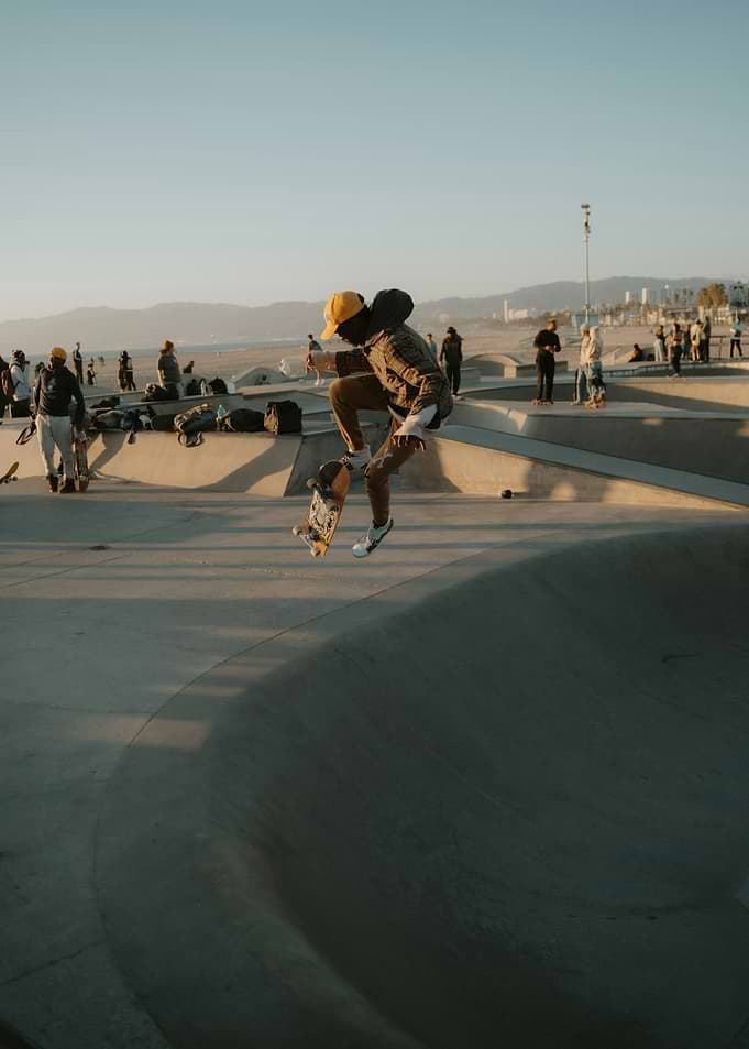 Skateboarder mid-air at sunset