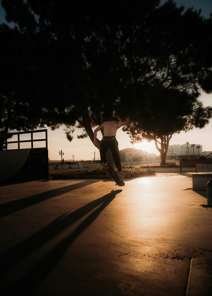 Skateboarder performing a trick at sunset