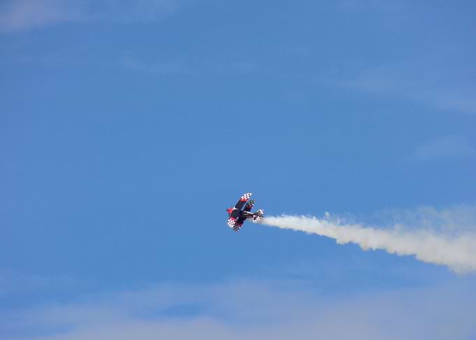Biplane Performing Aerobatics with Smoke Trail