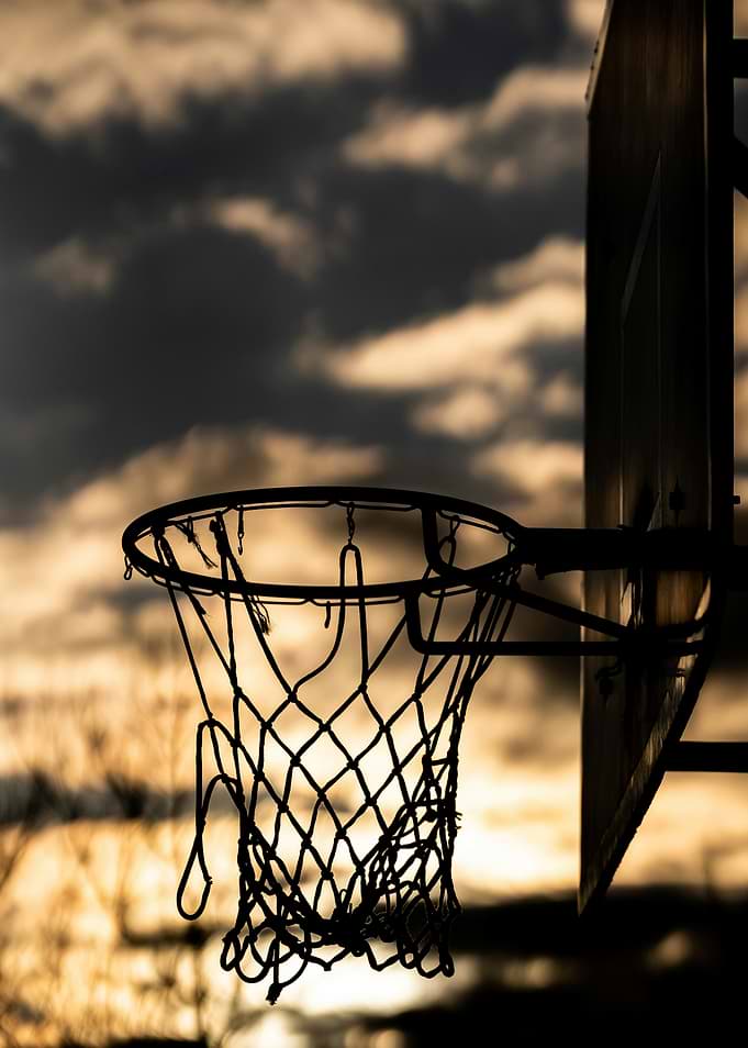 Basketball hoop silhouette at sunset