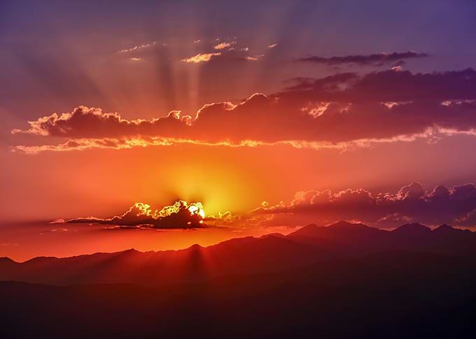 Sunset Over Mountains with Sun Rays