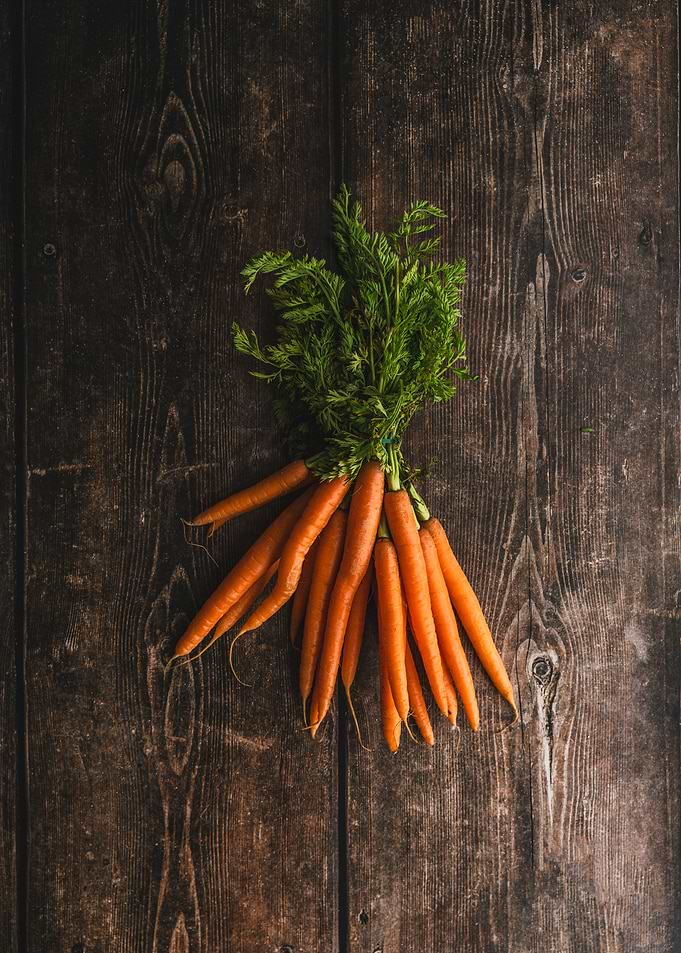 Fresh Carrots on Wooden Background