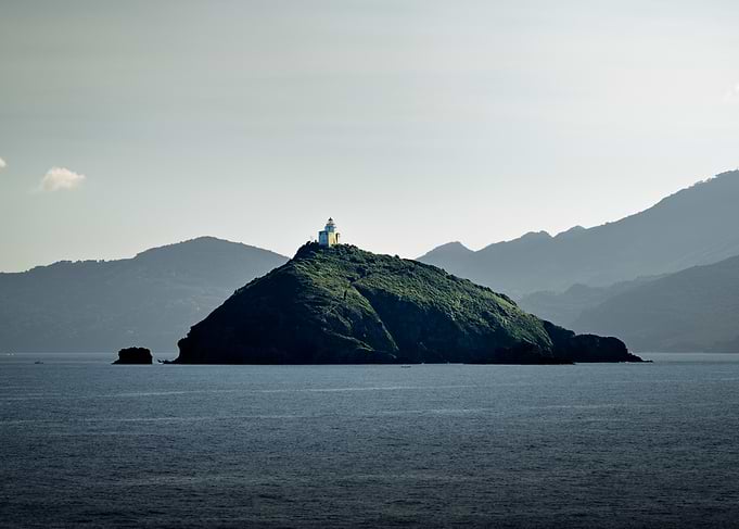 Palmaiola island lighthouse overlooking the sea, Italy