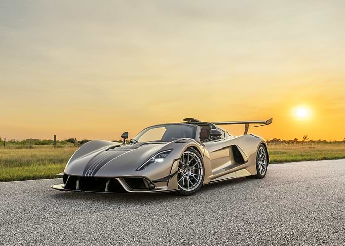 Golden hypercar at sunset
