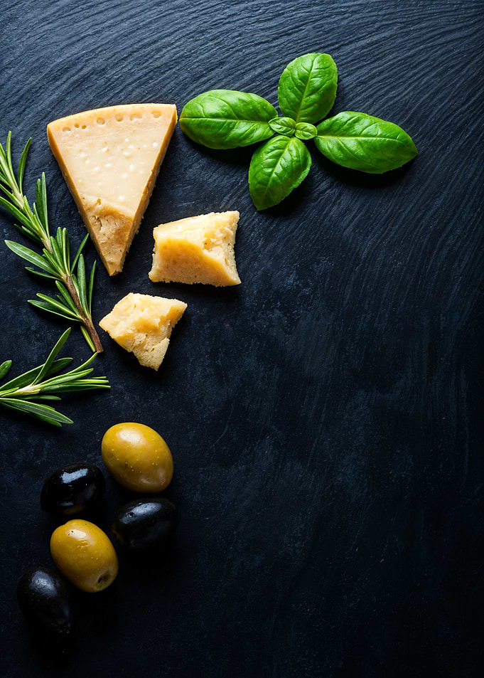 Parmesan cheese with olives and herbs