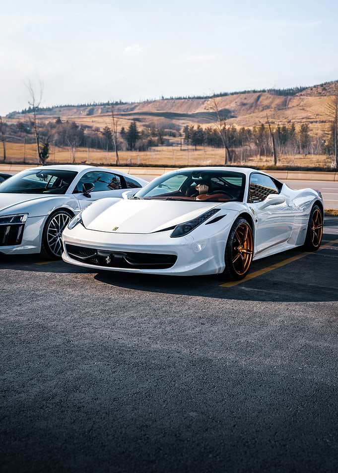 White Ferrari and Audi Sports Cars