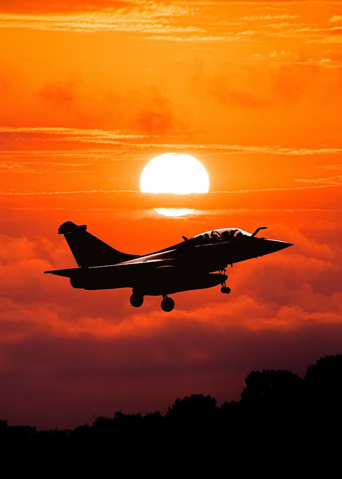 Fighter Jet Silhouetted Against Sunset Rafale B