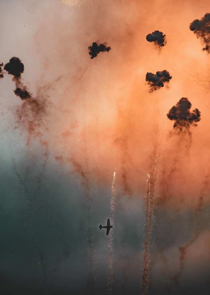 Airplane flying through fireworks