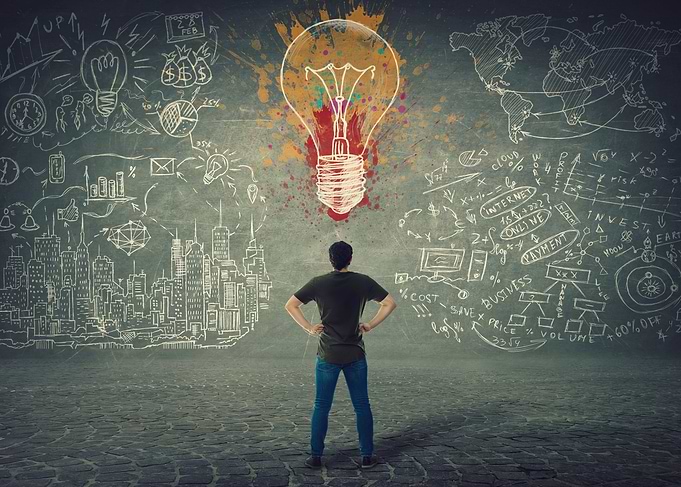 Man facing a bright idea lightbulb