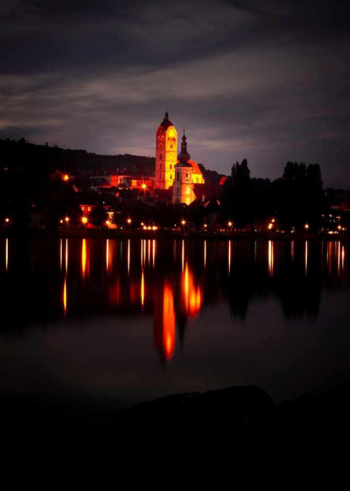 Cityscape at Night with Lake Reflection