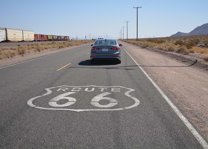 Route 66 road sign with car