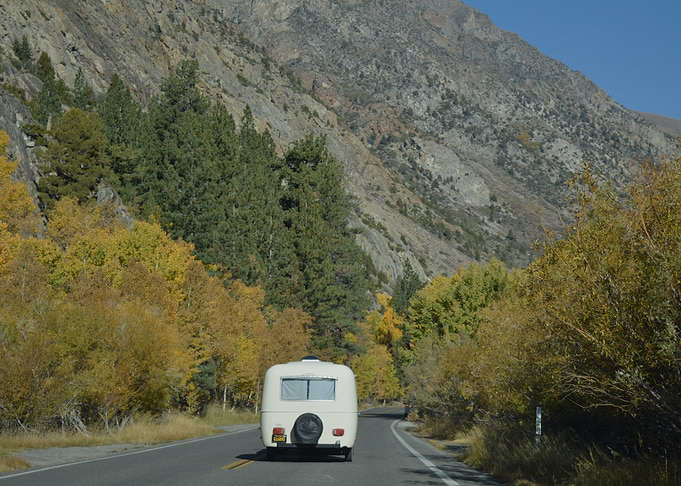 RV traveling through autumn mountains