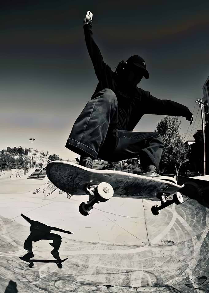 Skateboarder mid-air trick in skatepark