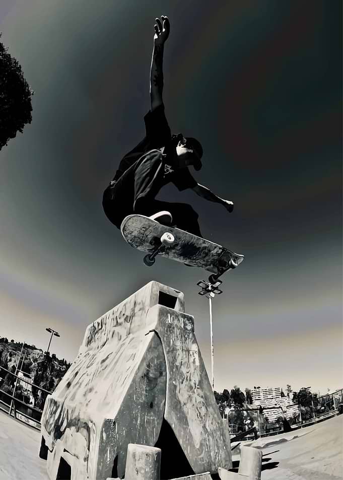 Skateboarder performing a trick over obstacle
