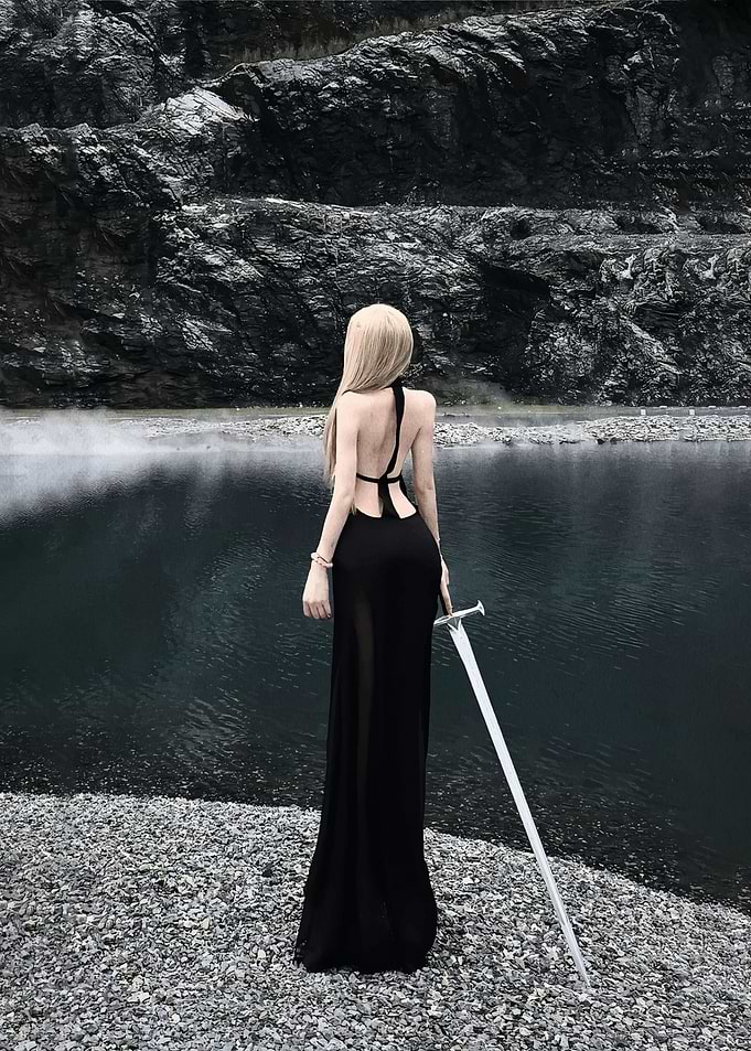 Woman in black dress with sword