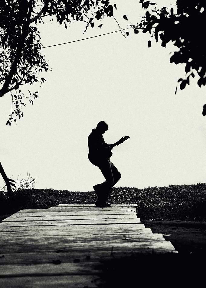 Silhouette of a guitarist playing outdoors