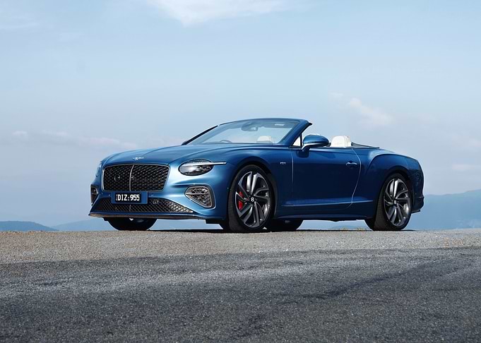 Blue Bentley Convertible on Scenic Road