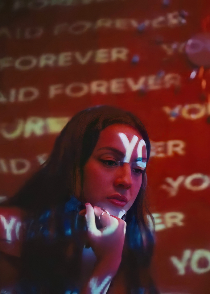 Woman with 'YO' and 'FOREVER' projected on her