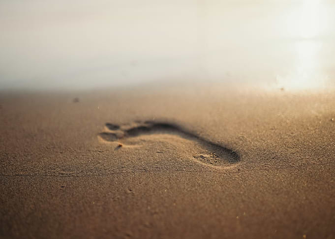 Footprint in the Sand at Sunset