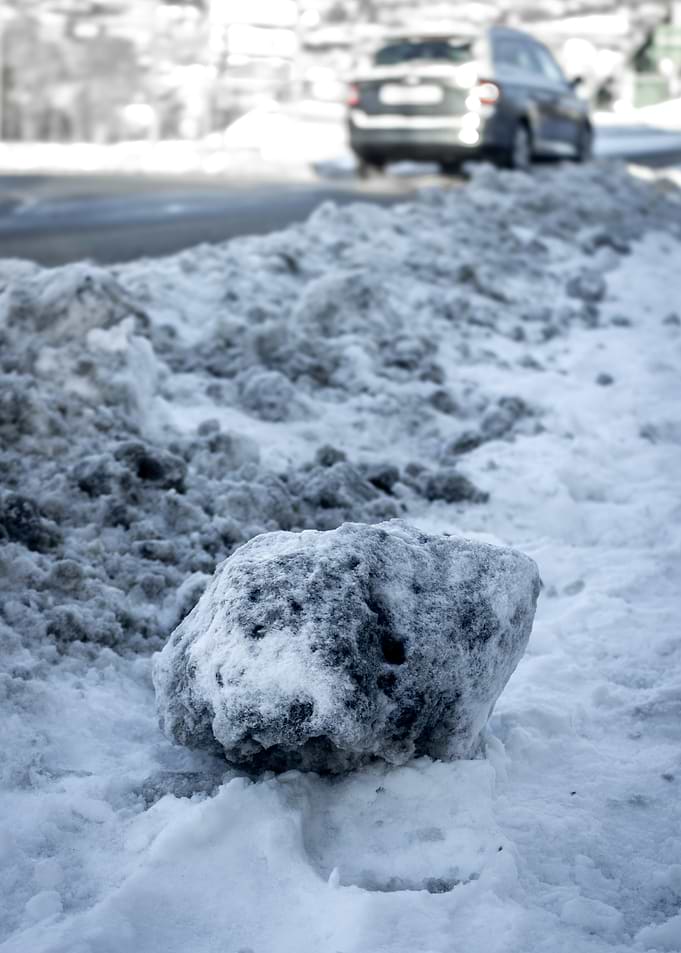 Snowy roadside with a car