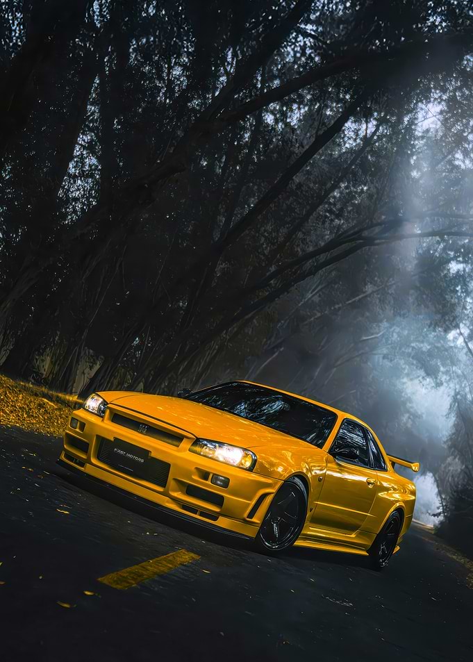 Yellow Nissan Skyline R34 on Misty Road