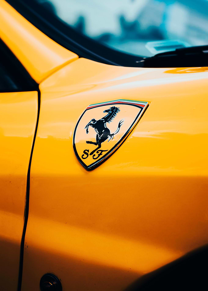 Yellow Ferrari with Prancing Horse Emblem