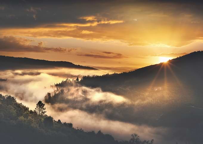 Sunrise over misty mountains