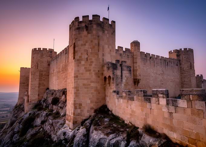 Castle on a rocky cliff at sunset