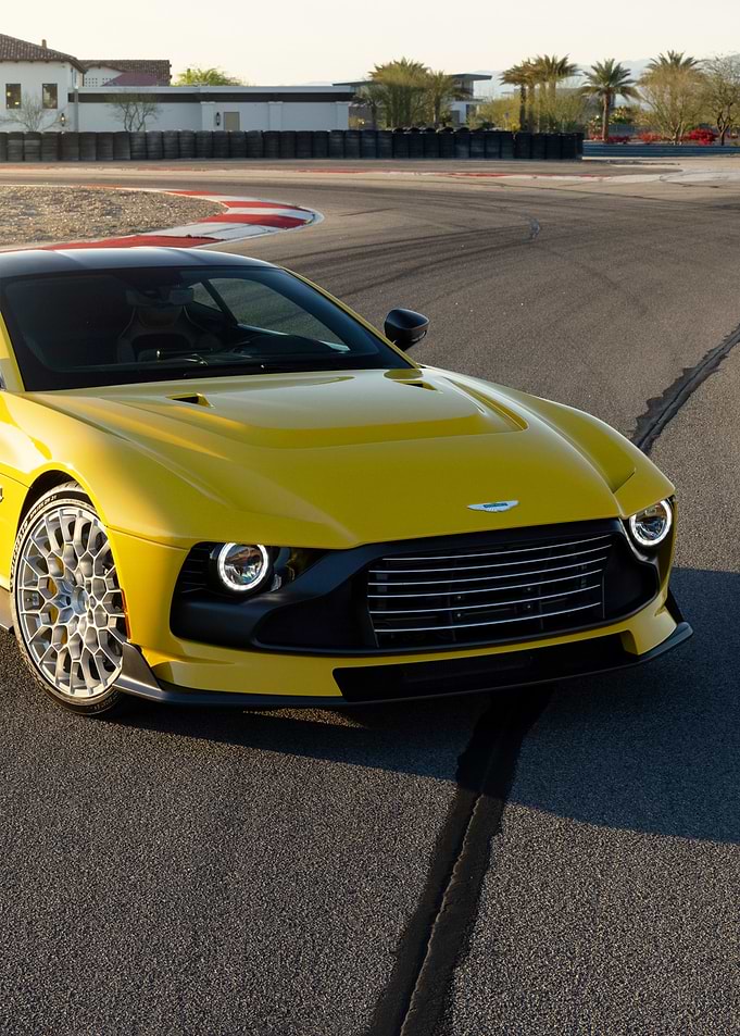 Yellow Aston Martin on a Race Track