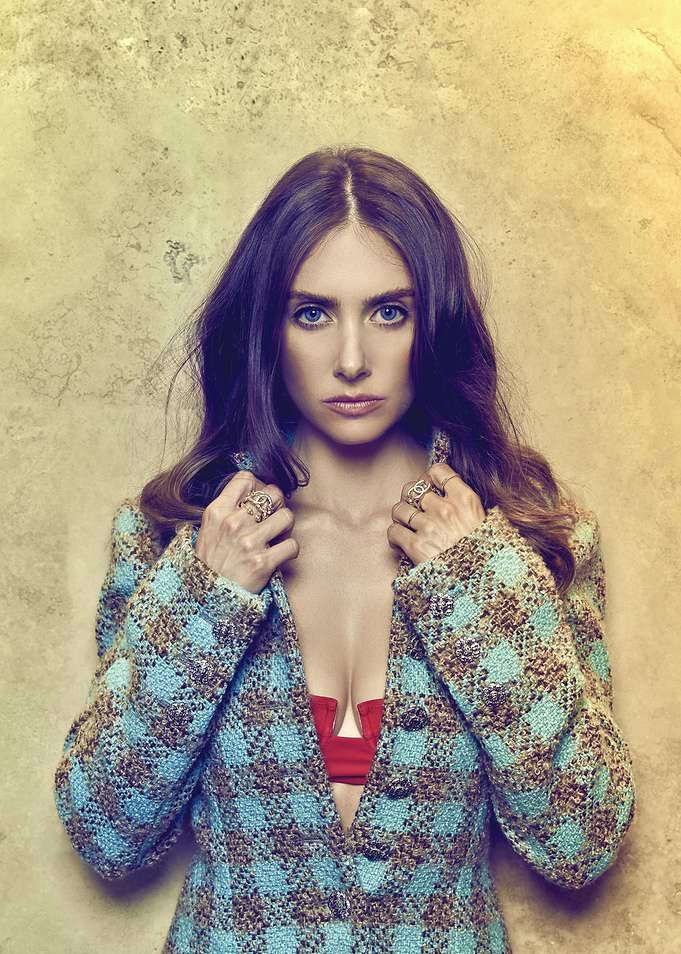 Woman in patterned jacket and red top
