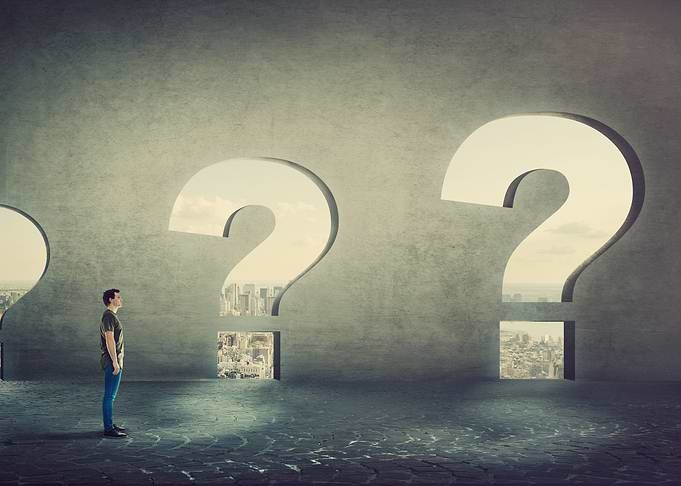 Man faces question marks with city view