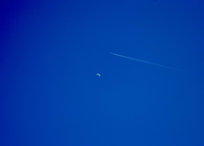 Airplane and Moon in Blue Sky